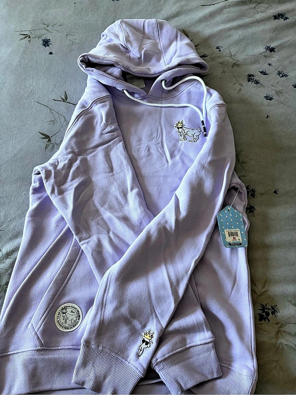 New GOAT USA lavender hoodie is size adult XS.
